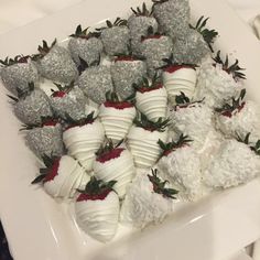 a platter filled with lots of white chocolate covered strawberries