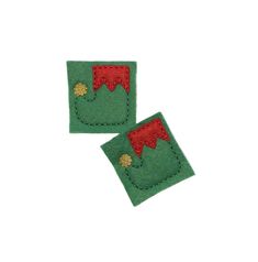 two pieces of felt with red and green designs on them