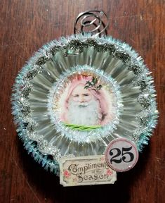 a glass ornament with an image of santa claus in the center on it