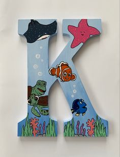 the letter k is painted with an image of fish and sea animals