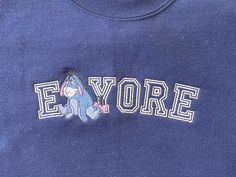 Our Eeyore Sweatshirt is so cozy!  Perfect for those days where your inner Eeyore wants you to stay home and watch Winnie the Pooh! Embroidered crews are a classic design that will never go out of style!  And they will last as long as the crew!  No pealing or cracking here! All of our sweatshirts are Unisex in size, Gilden heavy cotton brand.  See listing picture for size dimensions.  Unisex sizes Small- 2XL Multiple colors.  We also have some larger sizes in black and white.  Message if you nee Eeyore Clothes, Eeyore Outfit, Eeyore Sweatshirt, Gold Dog Collar, Mickey Sweatshirt, Writing A Love Letter, Hundred Acre Woods, Neutral Rainbow, Collar Clips