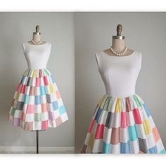 a dress made out of colorful squares on a mannequin