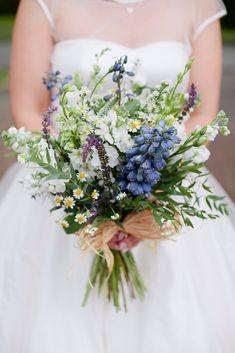 a bride holding a bouquet of flowers in her hands