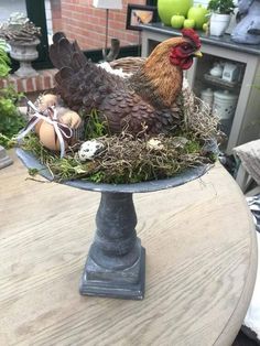 a chicken sitting on top of a plate with eggs in it's beaks