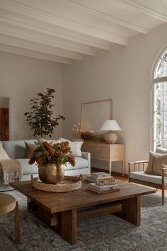 a living room filled with furniture and a large window