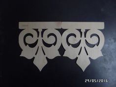 an ornate design on the side of a black wall in a room with dark walls