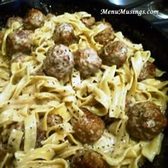 some meatballs and noodles are in a black bowl