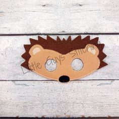 a hedgehog mask is shown on a wooden surface