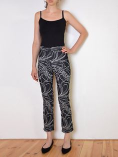 Cool vintage pants made of a bit stretchy, thinner denim-like fabric. Black with large print of leafs outline. Mid-waisted slim fit with cropped legs. Button and zip closure. One small pocket on the front. Era: 90's, made in Italy Fabric: 78% cotton, 26% polyamide, 2% elasthane Condition: very good, slightly washed off Estimated size: S /XS (please, check the measurements) Measurements (measured flat, need to be doubled to get the circumference): Waist: 33 cm / 13 inches, has a little bit of str Y2k Fitted Straight Leg Bottoms, Y2k Fitted Straight Leg Pants, Fitted Black Bottoms With Graphic Print, Fitted Y2k Style Bottoms, Y2k Straight Leg Pants With Graphic Print, Y2k Style Straight Leg Pants With Graphic Print, Y2k Style Straight Leg Graphic Print Pants, Y2k Style Fitted Trousers, Y2k Fitted Trousers