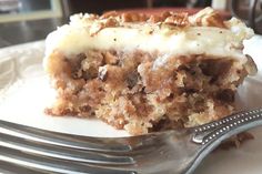 a piece of cake sitting on top of a white plate next to a silver fork