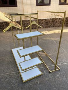 a set of three tables sitting on top of a cement floor