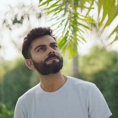 a man with a beard looking up at the sky