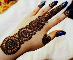 a woman's hand with henna tattoos on it