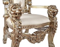 a golden lion head chair with white upholstered seat