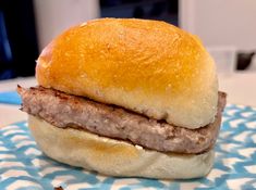 a hamburger sitting on top of a blue and white plate