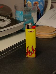 a yellow lighter sitting on top of a table