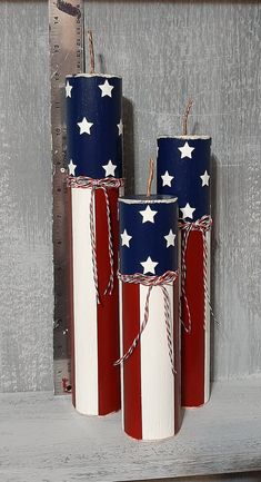 three red, white and blue candles with stars on them