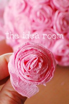 a person holding a pink flower in their hand with the words, the idea room