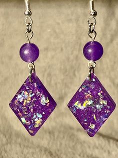 Fun small sized Dimond resin earrings with beads.  These earrings have a solid purple color resin base, multi color holographic chunky glitter, and a purple bead.  Very light weight.  Ready to ship. Iridescent Glitter Earrings As Gift, Iridescent Glitter Earrings For Gift, Hypoallergenic Purple Round Bead Earrings, Iridescent Dangle Resin Earrings, Purple Hypoallergenic Dangle Crystal Earrings, Purple Glitter Jewelry Gift, Purple Glitter Jewelry For Gifts, Sparkling Purple Jewelry Gift, Purple Glitter Party Jewelry