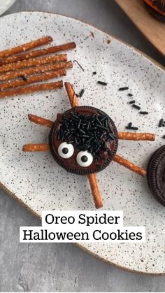 spooky oreo spider halloween cookies on a wooden board