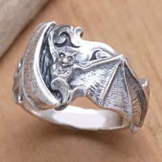 A bat with spread wings takes center stage in this cocktail ring reserved for those who love jewelry that breaks the mold. The ring is crafted from sterling silver with a combination finish and designed by artisan Dewa Arimbawa in Bali. Unique Sterling Silver Halloween Rings, Unique Sterling Silver Rings For Halloween, Vintage Sterling Silver Ring For Halloween, Vintage Sterling Silver Rings For Halloween, Sterling Silver Winged Rings In Silver, Bat Jewelry, Silver Cocktail, Love Jewelry, Center Stage