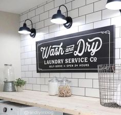 wash and dry laundry service sign hanging on the wall above a washer and dryer