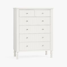 a white chest of drawers with four drawers