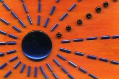 a wooden table topped with lots of blue pins and screwdriver's on top of it