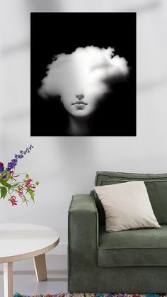 a black and white photo of a woman's face in the clouds