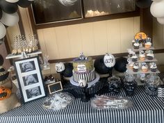 a table topped with lots of cakes and cupcakes