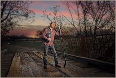 a man standing on top of a train track holding a metal object in his hand