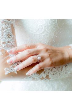 a woman wearing a wedding ring and holding onto her hand