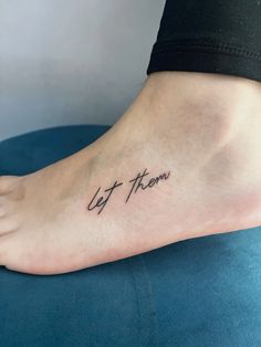 a woman's foot with the word let them go written on her left side