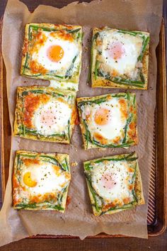 four square pieces of food with eggs on them