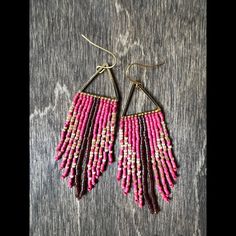 pink and brown beaded earrings on wooden background