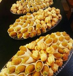 several trays filled with different types of food on top of a table next to each other