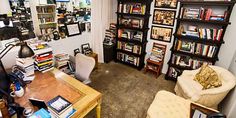 a room filled with lots of books and furniture