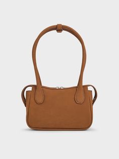 With a softly buffed, pleasingly tactile finish, this Bosie top handle bag in chocolate brown will warm up your fall-winter looks. Featuring two elongated handles and a distinctive shape, this cute and chic piece makes for a cosy everyday companion. Equipped with a zip closure that will keep your belongings secure, it exudes a modern femininity that can be dressed up or down to suit the occasion -- it will work well for both work days and the weekends. Charles Keith, Handle Bag, Winter Looks, Chocolate Brown, Top Handle, Top Handle Bag, Handles, Fall Winter, Tote Bag