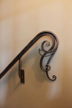 an old fashioned metal stair rail on the wall