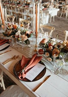 the table is set with flowers and candles for an elegant dinner or wedding reception,