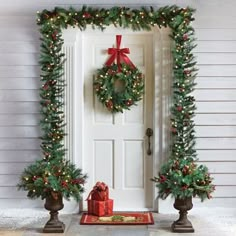 two wreaths on the front door with presents under them