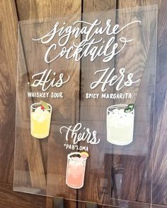 a glass sign that says signature cocktails with four different drinks