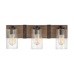 three light bathroom fixture with clear glass and wood accents on the sides, in an old - fashioned finish