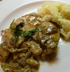 a white plate topped with meat and rice