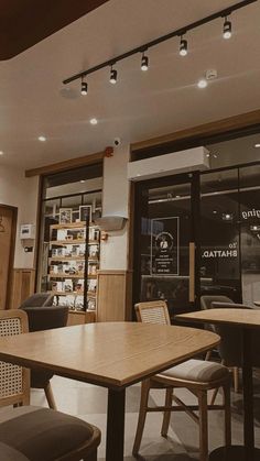 an empty restaurant with wooden tables and chairs