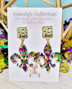 Purple green and gold fun Mardi Gras earrings. Made with glitter and resin, lightweight. Comes with gold tone studs, lead and nickel free. Will come gift wrapped, ships free. Hang down 2 in. from ear. Mardi Gras Earrings, Free Will, Plastic Earrings, Purple Green, Earring Backs, Mardi Gras, Pink Grey, Gold Glitter, Green And Gold