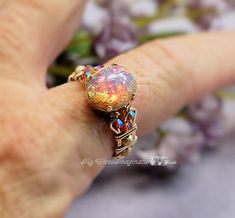 "Handmade Pink Opal Vintage West German Glass from the 1950's Hand Crafted Wire Wrapped Ring Original Signature Design Fine Jewelry October Birthstone The focal of this gorgeous ring is an extraordinary 12x10mm oval Vintage West German Glass Opal. They were handmade in the 1940's and 1950's, and no two are exactly alike. Fire in the stone can be viewed from every angle, and folks are always amazed when they see the one I wear, and find out it's not a 'real' opal. The high quality stone settings Pink Opal Ring, Opal Ring Vintage, Gorgeous Wedding Rings, Mystic Topaz Ring, Rose Vintage, Wire Wrapped Rings, Handmade Wire, Opal Ring, Wrap Rings