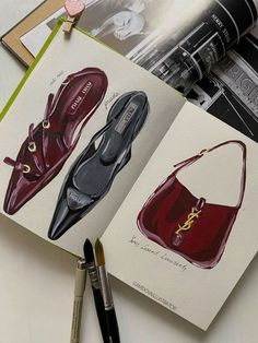 an open book with pictures of shoes and purses on top of it next to a pen