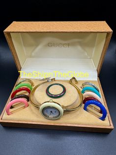 **Authentic Gucci 12 Bezel Watch** **Pre-loved, good condition** - 11/12.2 0999977 - New battery - Currently meets timekeeping standards - Evaluated by a Watch Specialist - Fits up to a 6.25-inch wrist - Clear crystal glass - Comes with 10 acrylic bezels, 2 metallic bezels, and a Gucci box  as seen in the photos Note: The middle part of the watch bracelet is fading, making it look slightly like a two-tone watch band.  Please check all photos for the actual size and condition. **Free shipping wit Modern Gucci Watch Accessories With Subdials, Timeless Gucci Watch With Polished Finish, Gucci G Timeless Watch Gold, Gucci Bezel Watch Vintage, Vintage Gucci Watch Interchangeable, Gucci Watch, Two Tone Watch, Watch Movement, Women Wrist Watch