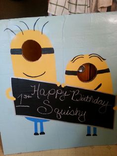 a birthday card with two minion characters holding a sign that says happy birthday to squissy